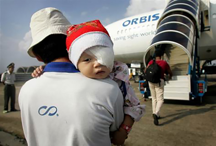 Young child about to be treated on The ORBIS Flying Eye Hospital.