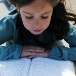 Young girl reading book.